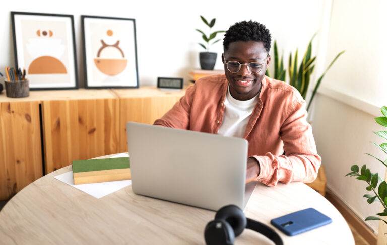 Man working on laptop to leverage AI for his business.