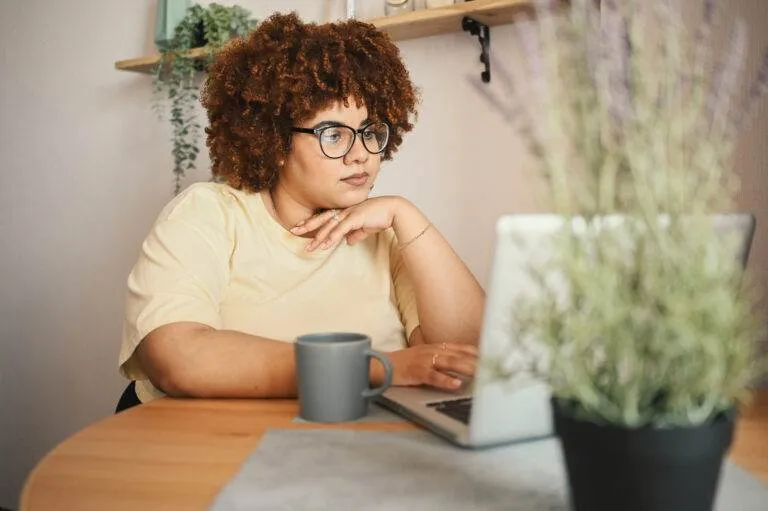 Woman building a landing page on a laptop.